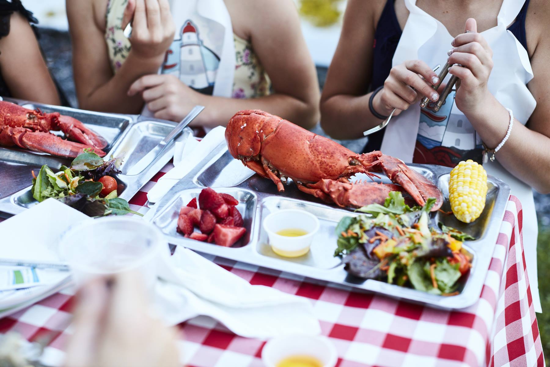eating lobster on a picnic table
